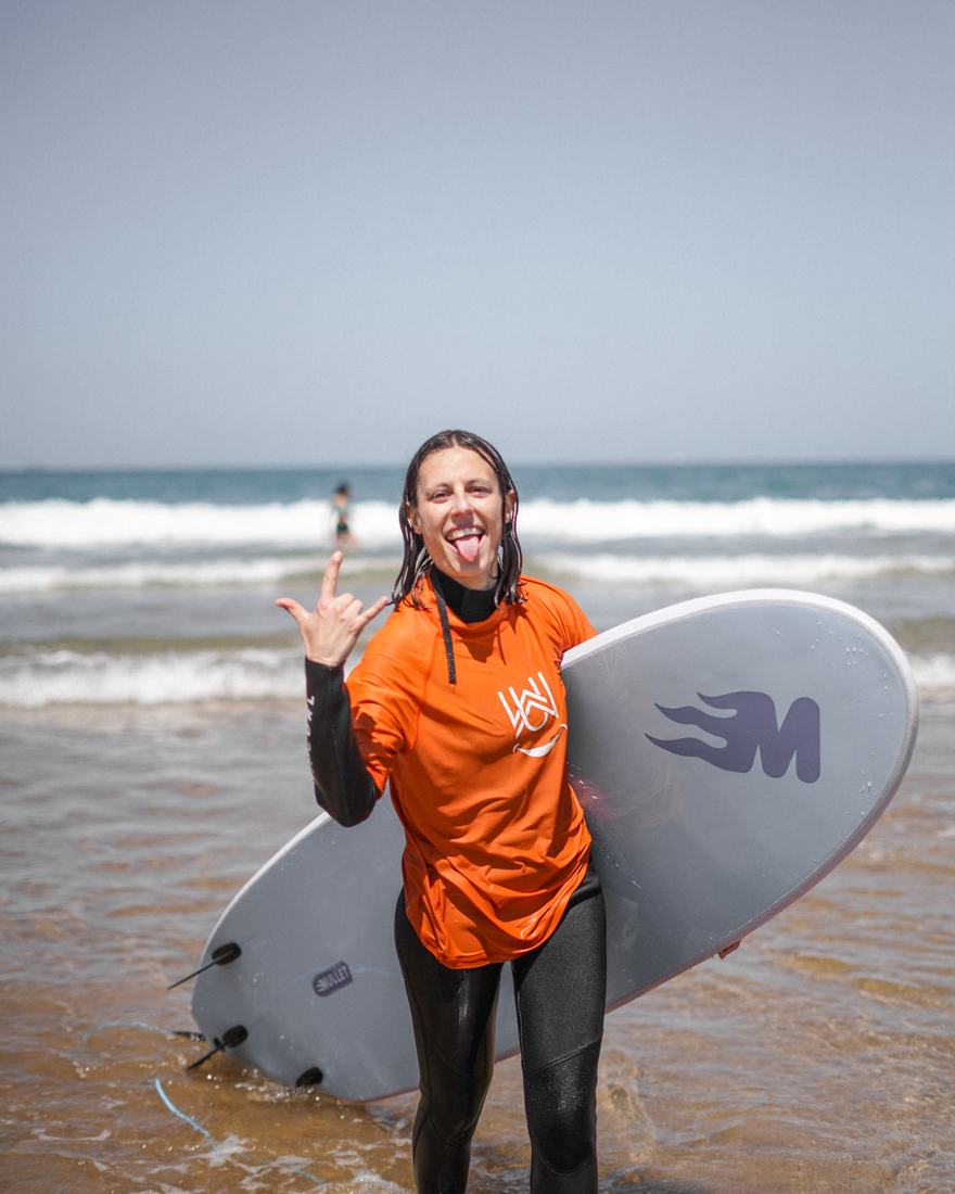 A Wave Rise guest coming out of the water after her first session
